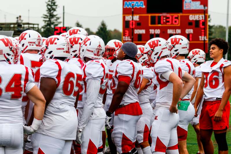 a group of football players in a huddle