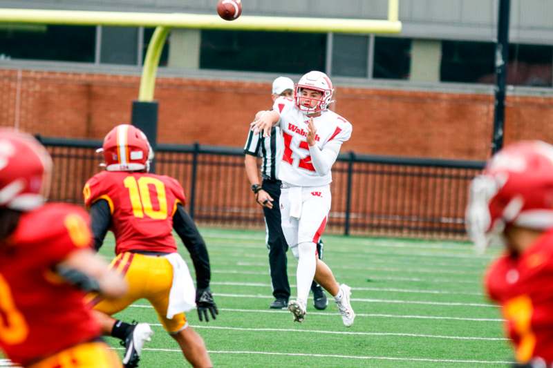 a football player in a helmet running to catch a football