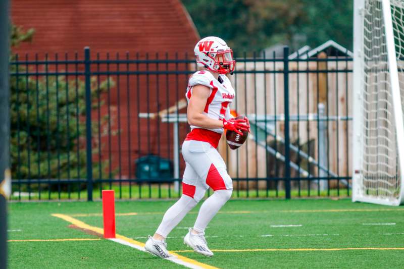 a football player running with a football