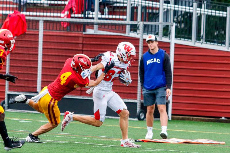 a football player running with another player in the back