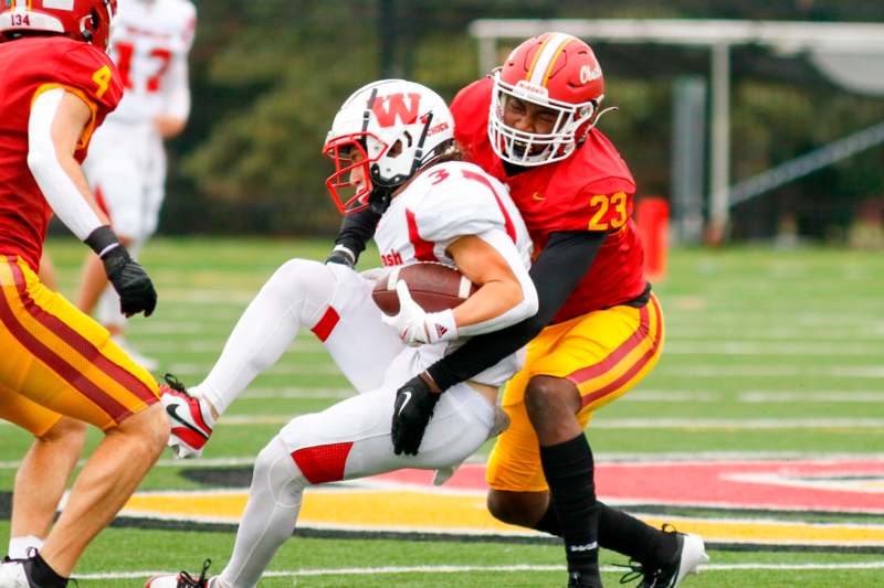 a football player being tackled by another football player