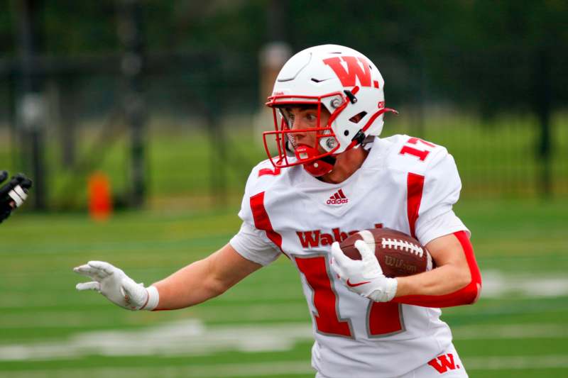 a football player holding a football