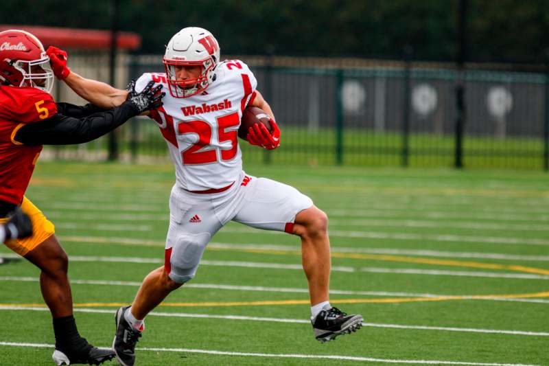 a football player running with a football