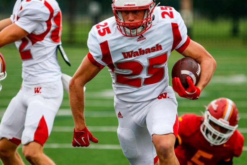 a football player running with a ball