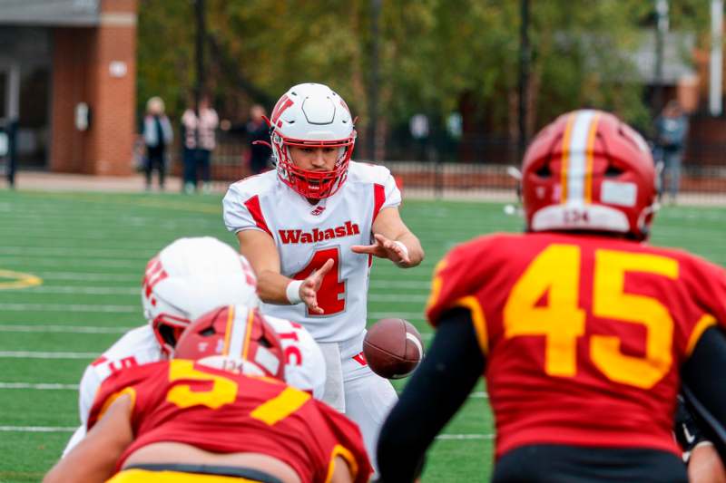 a football player in a helmet with a football in his hand