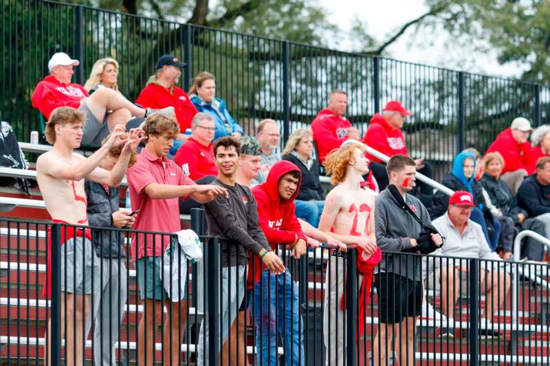 a group of people sitting on bleachers