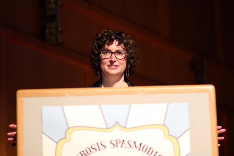 a woman standing behind a podium