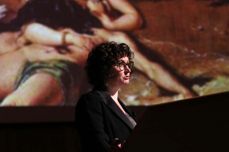 a woman standing at a podium