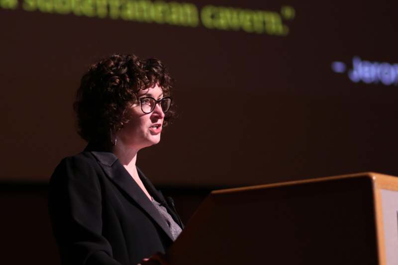 a woman standing at a podium