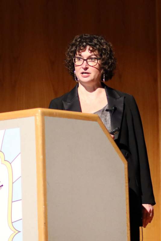 a woman standing at a podium