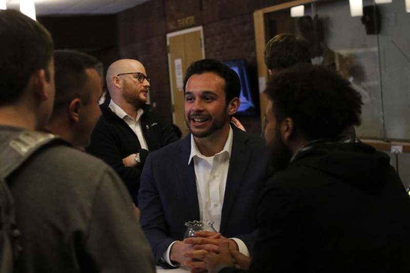 a man in a suit and white shirt