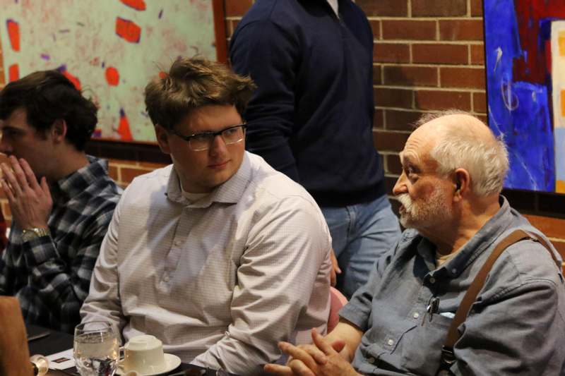 a group of men sitting at a table