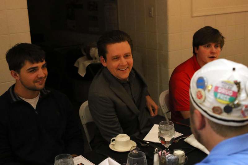 a group of men sitting at a table