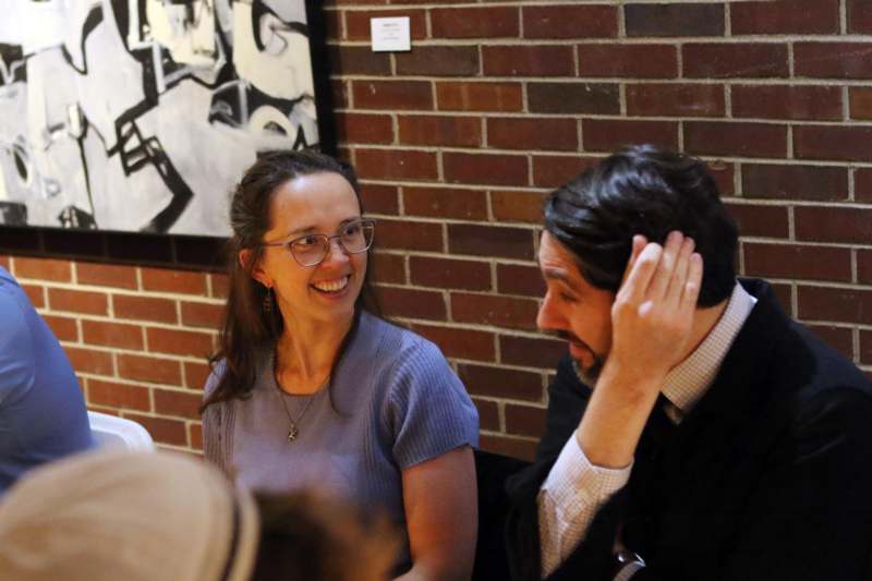 a man and woman sitting at a table