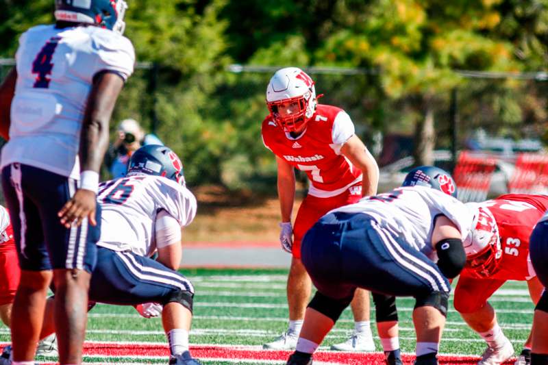 a football player in a red uniform on a field