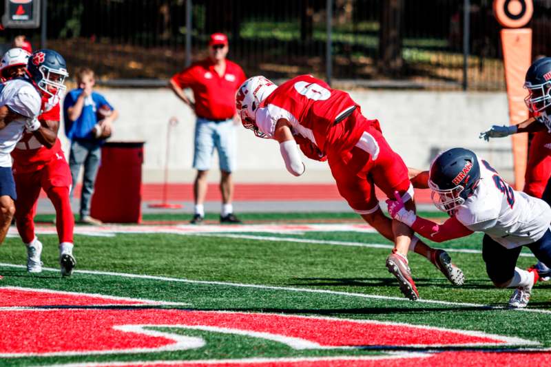 a football player diving for a ball