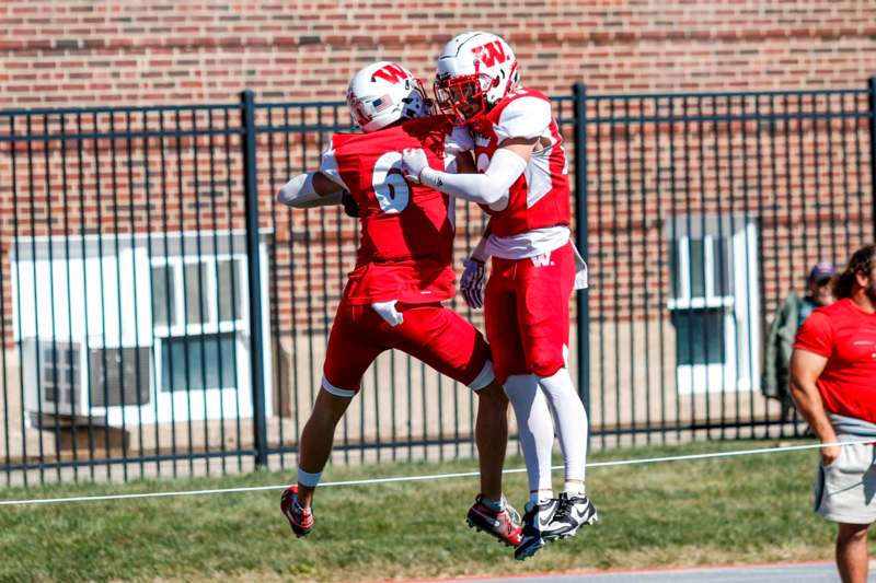 a group of football players in red uniforms