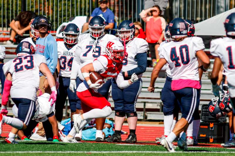 a football player running with a football in his hand