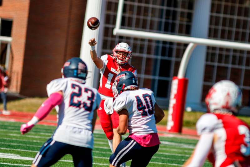 a football player throwing a football