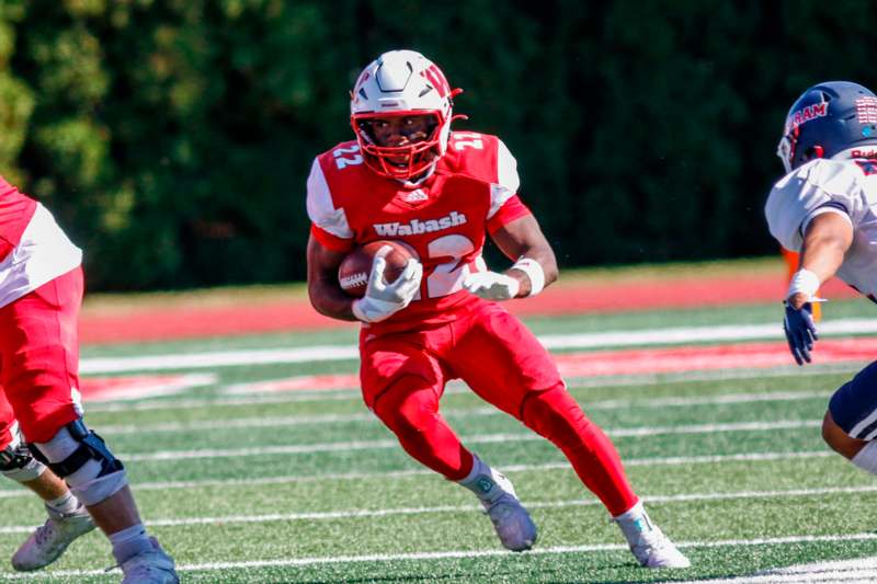 a football player running with a football