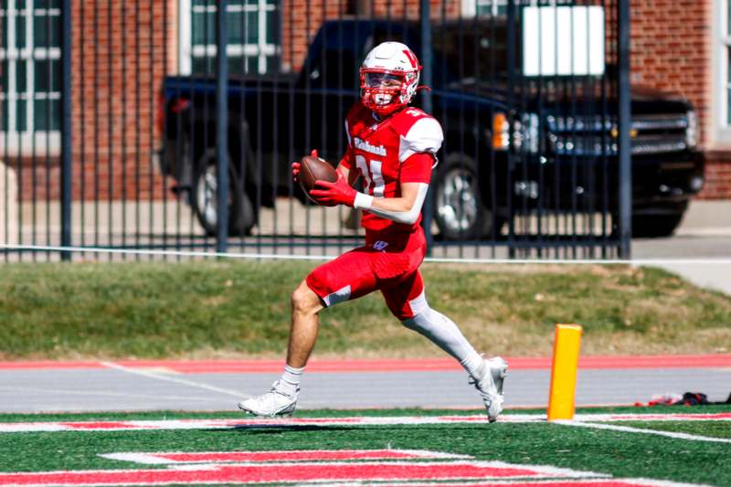 a football player running with a football