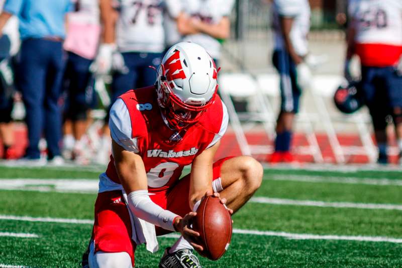 a football player kneeling on the ground