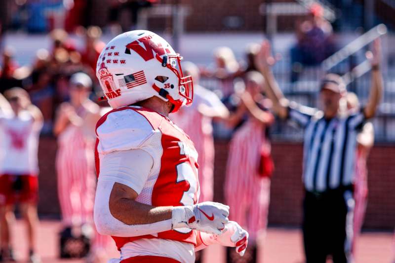 a football player in a red uniform