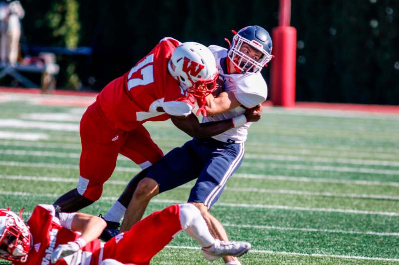 a football player being tackled by another football player