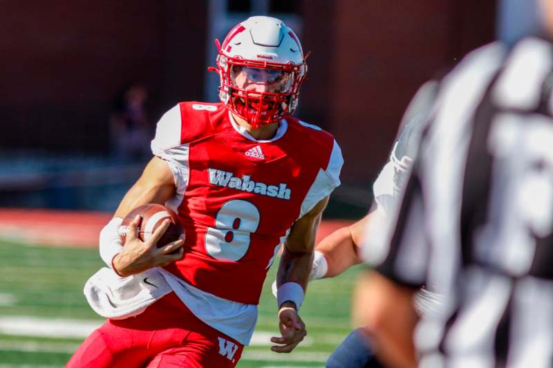 a football player running with a football