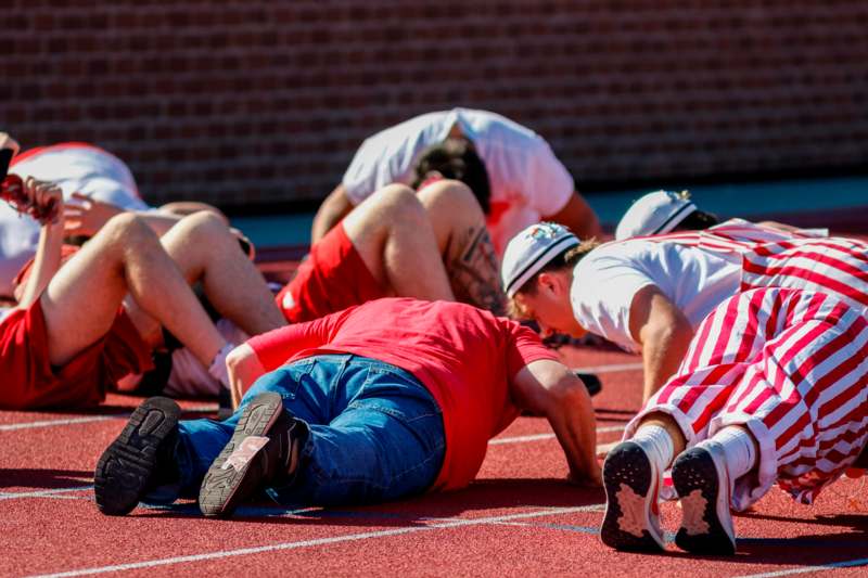 a group of people lying on a track