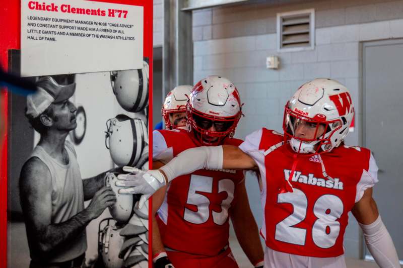 a group of football players in red and white uniforms