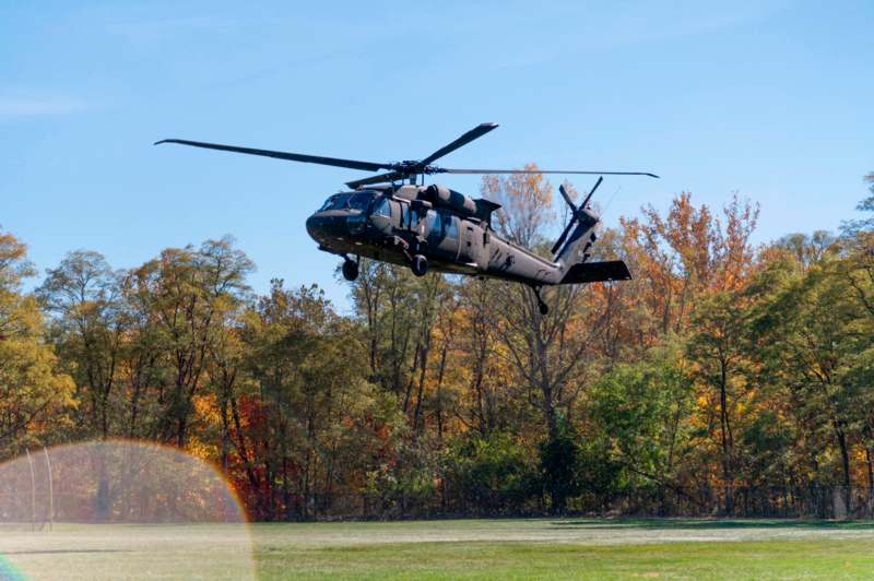 a helicopter flying over a field