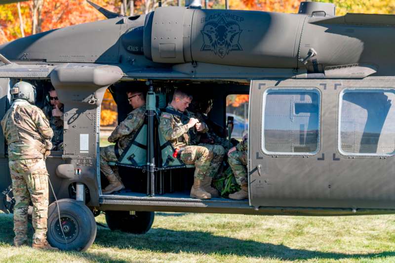 a group of soldiers sitting in a helicopter