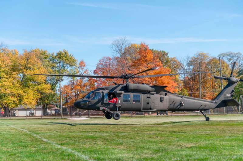 a helicopter flying over grass