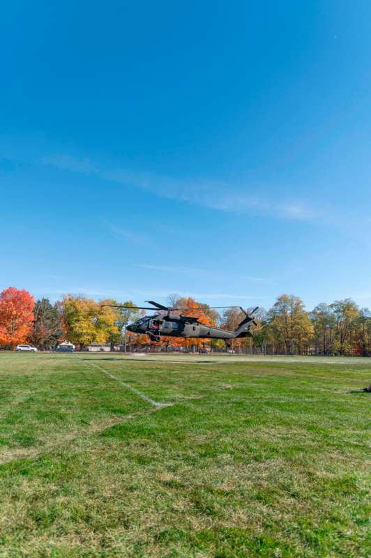 a helicopter flying over a field