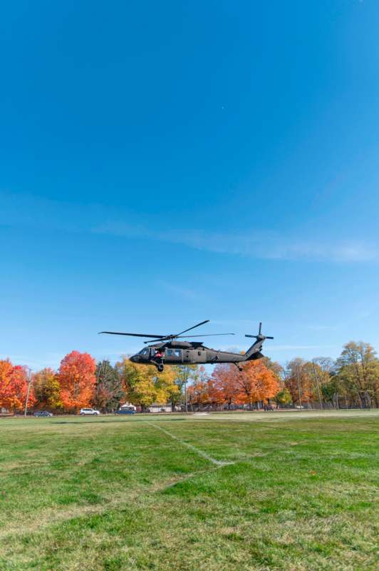 a helicopter flying over a field