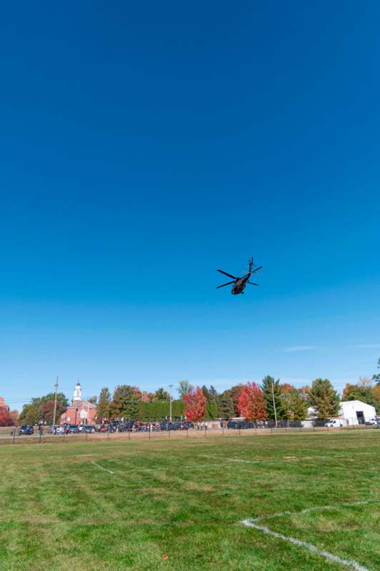 a helicopter flying over a field