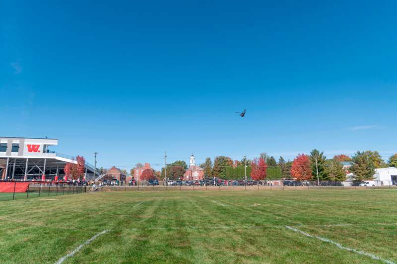 a helicopter flying over a field