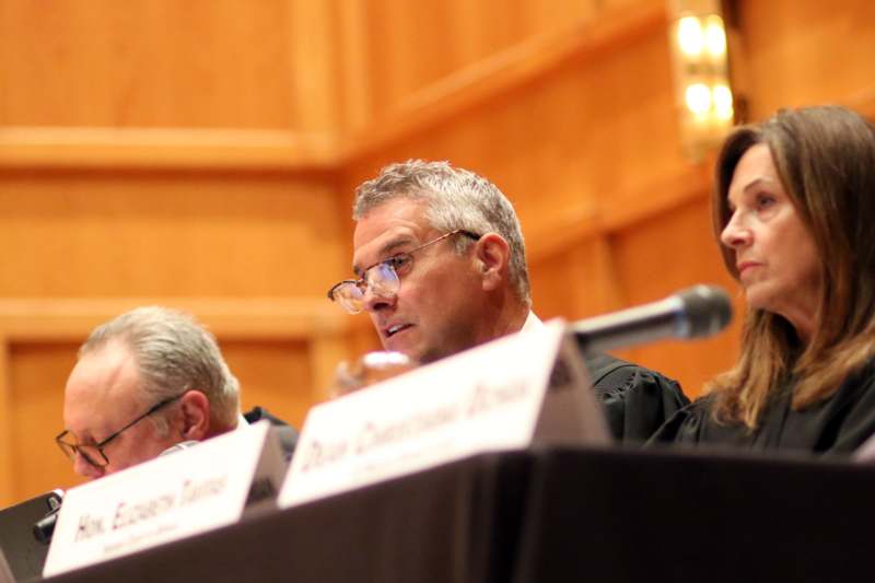 a group of people sitting at a podium