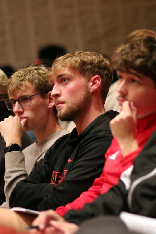 a group of men sitting in a row