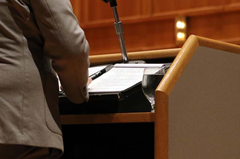 a person holding a pen and a clipboard