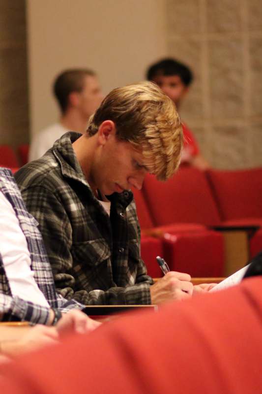 a man writing on a paper