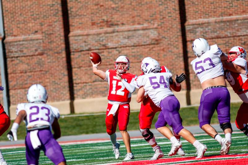 a football player throwing a football