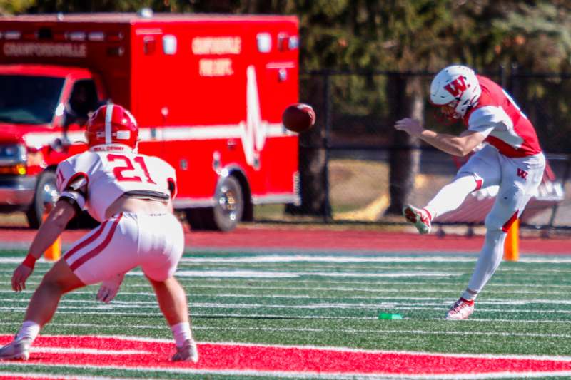 a football player kicking a football