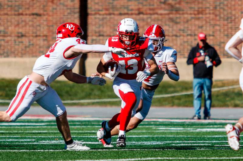 a group of football players running on a field