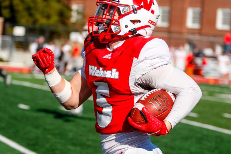 a football player running with a football