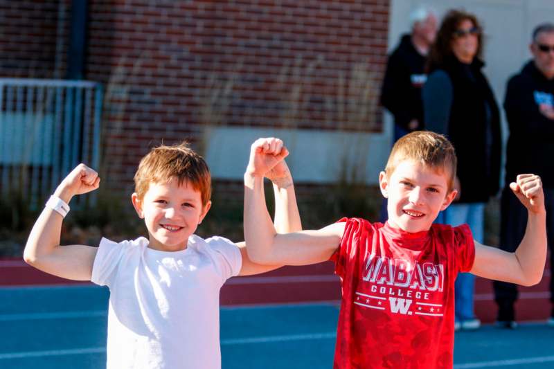 two boys flexing their arms