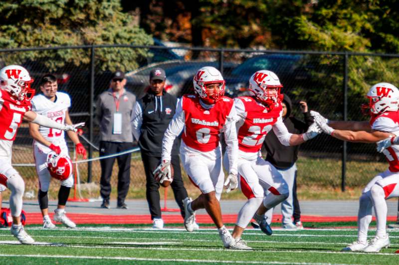 a group of football players running on a field