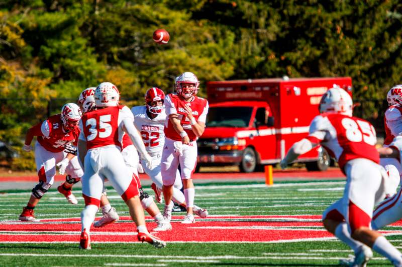 a football player throwing a football