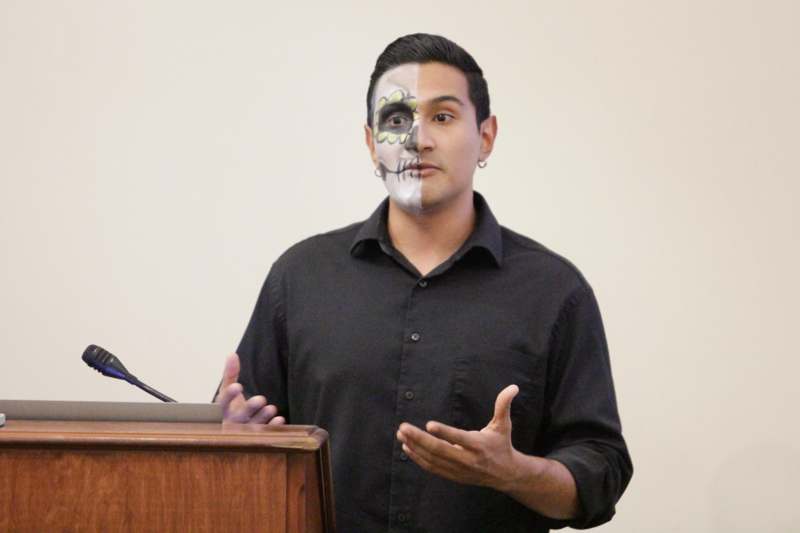 a man with face paint and a black shirt